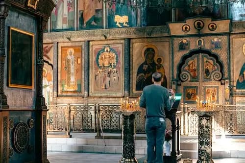 Orthodox church interior with candles before icons
